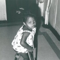 Young child with crutches.